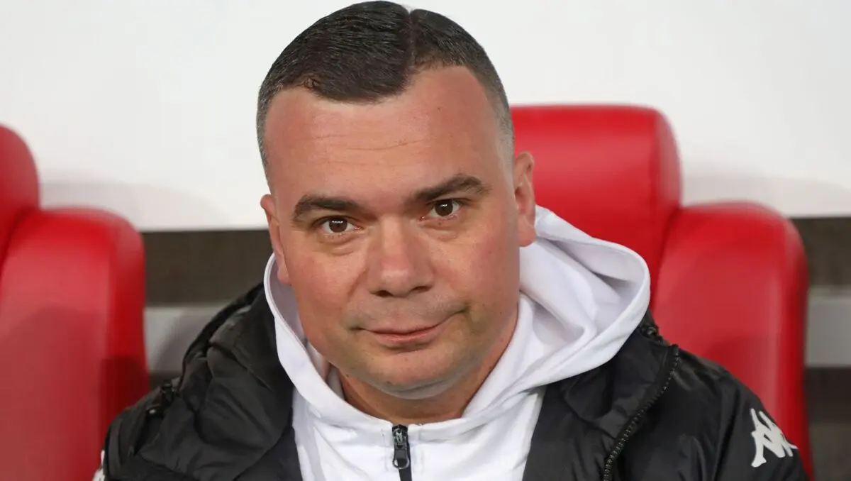 Portrait of Adrian Siemieniec wearing a Jagiellonia Białystok team jacket and white hoodie.
