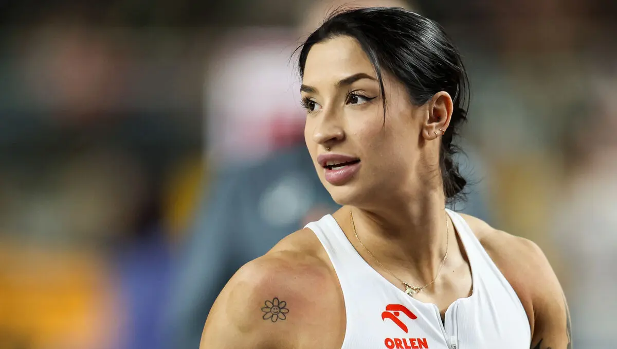 Portrait of Polish sprinter Ewa Swoboda wearing a white Orlen team athletic top
