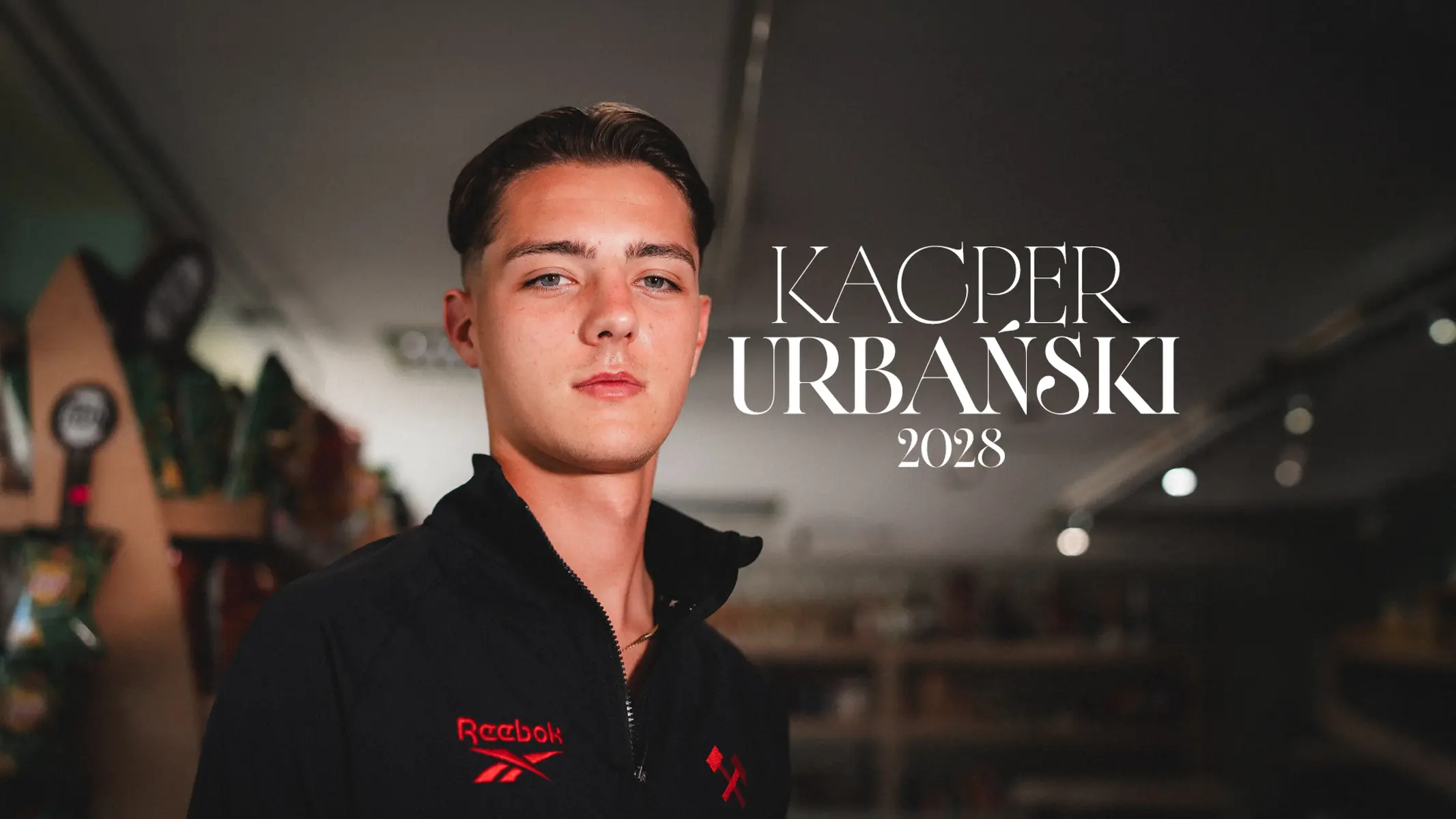 Portrait of Kacper Urbański wearing a black Reebok tracksuit jacket