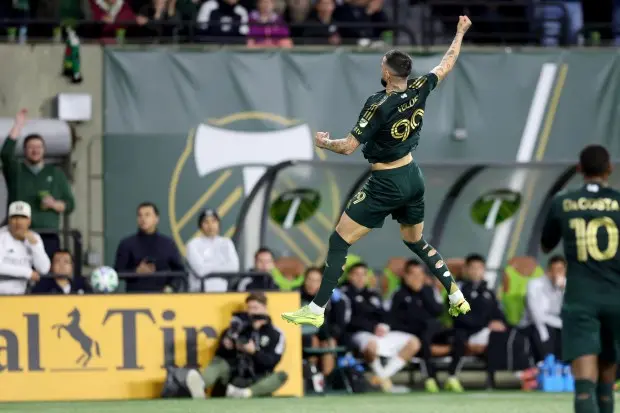 Kristoffer Velde of the Portland Timbers celebrating with arms raised during a match