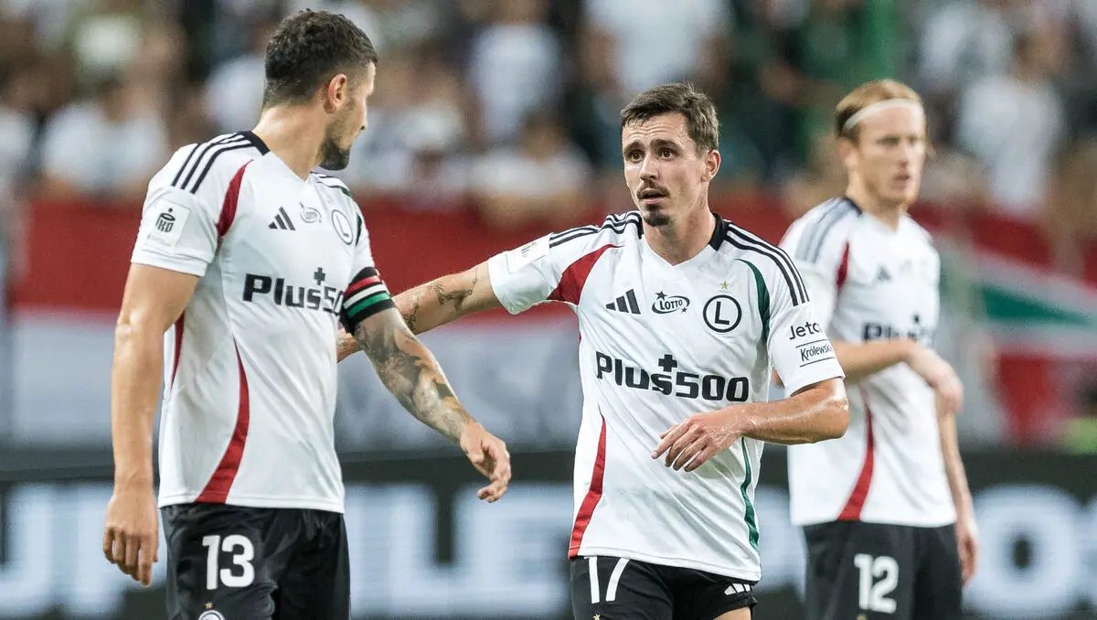 Legia Warszawa football players in white jerseys on the pitch during an Ekstraklasa match