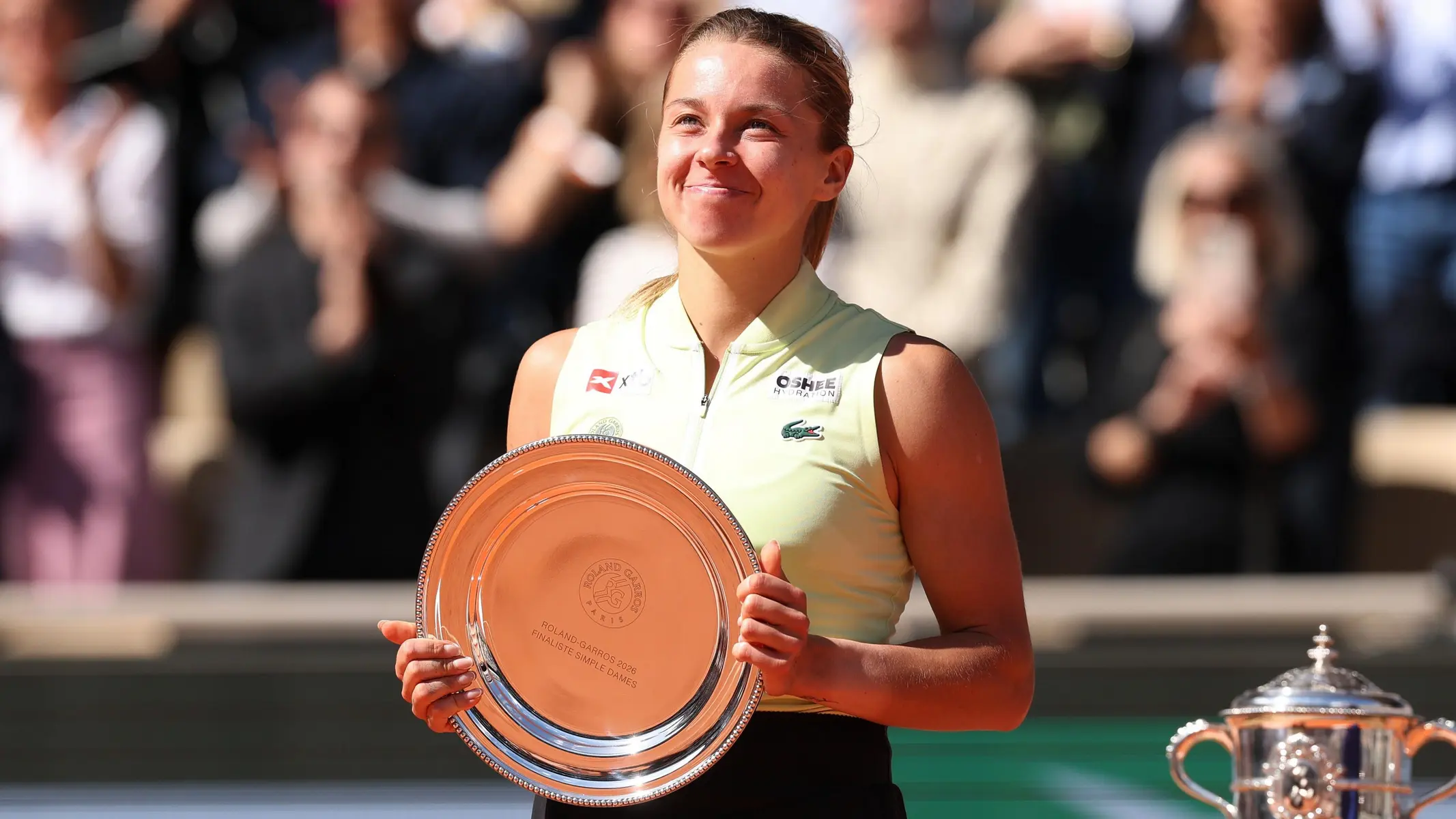 Maja Chwalinska smiling and holding a silver trophy plate at the Roland-Garros tennis tournament.