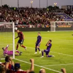 Dramatic MLS match scene showing Real Salt Lake scoring before Orlando City completes a comeback.