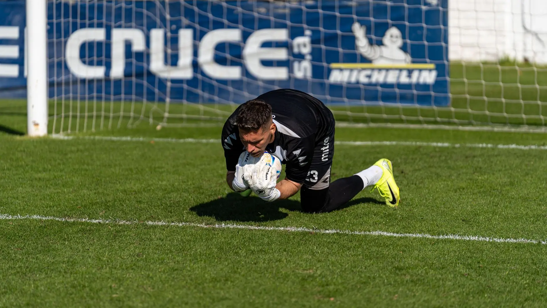 AS Monaco goalkeeper Mika Biereth diving on the grass during a football match