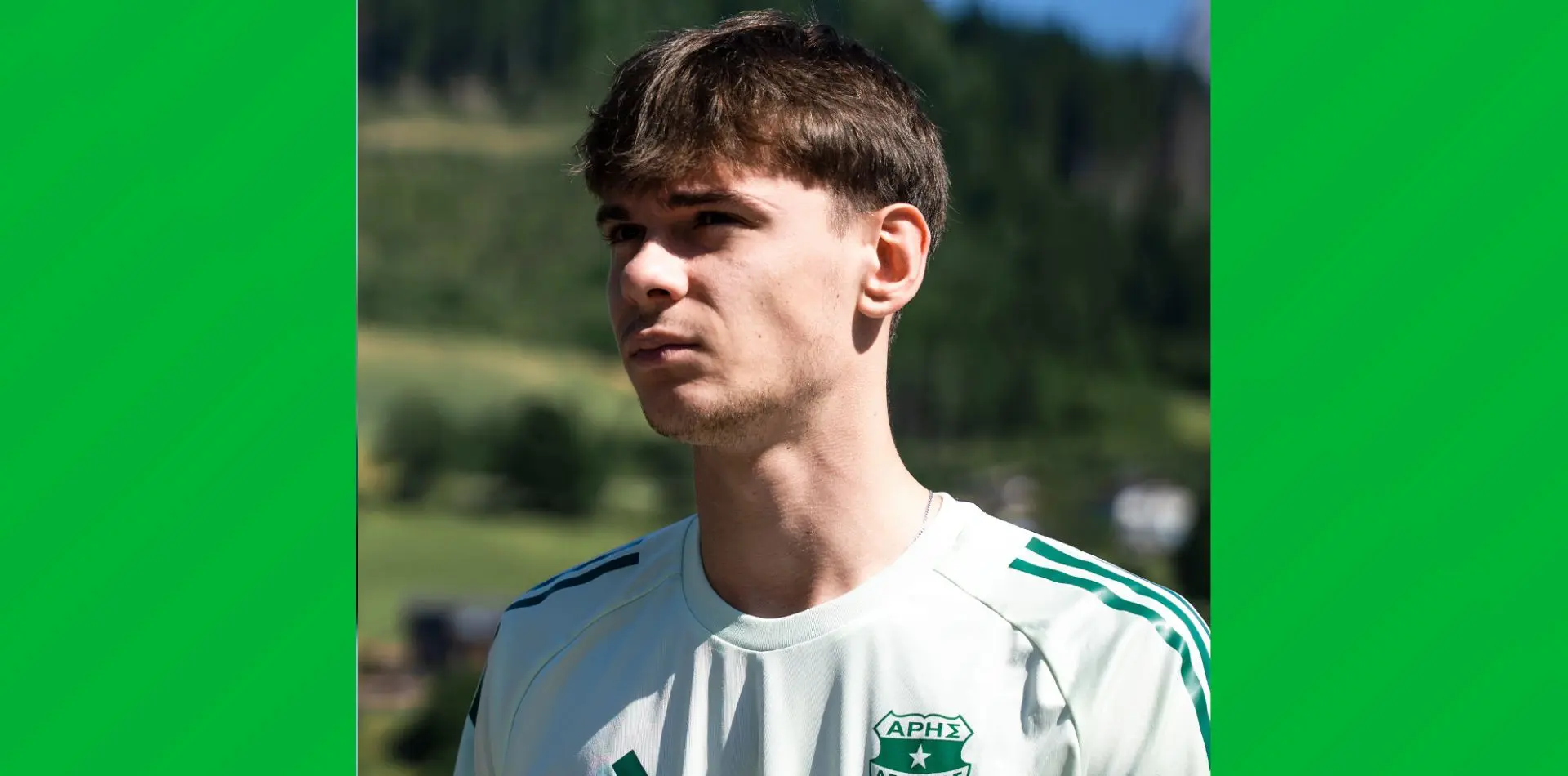 Portrait of Milosz Matysik wearing an Aris Limassol white and green training kit