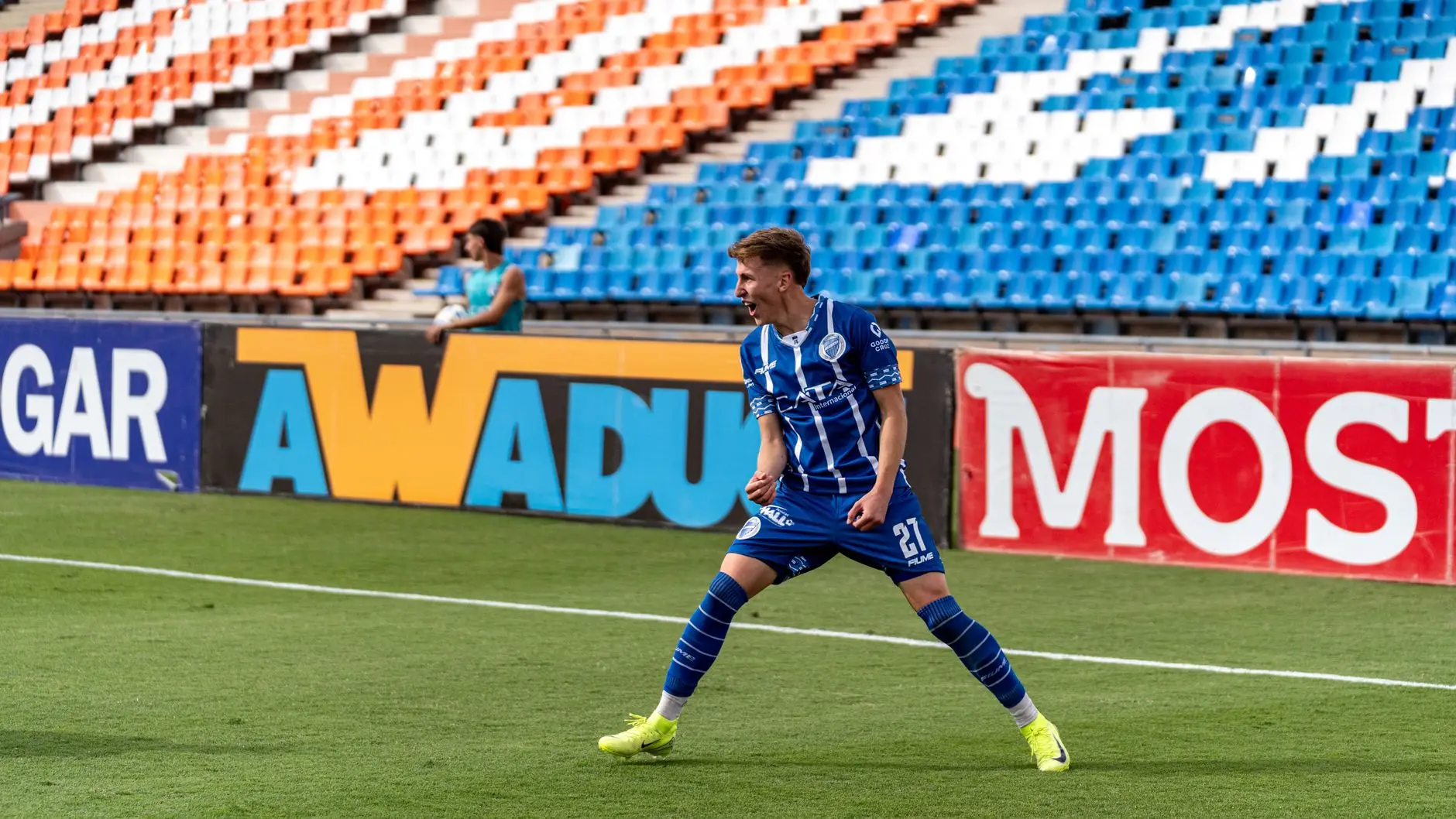 Sondre Liseth Gornik Zabrze football player celebrating on the field in a blue and white striped kit