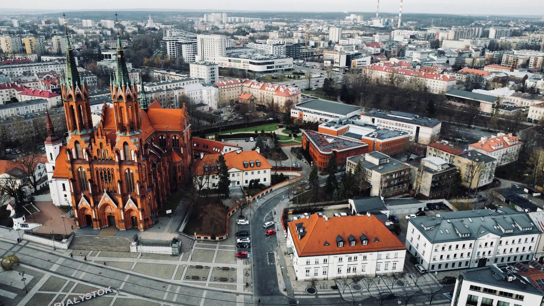 Aerial view of Bialystok city center featuring a large red brick Gothic cathedral