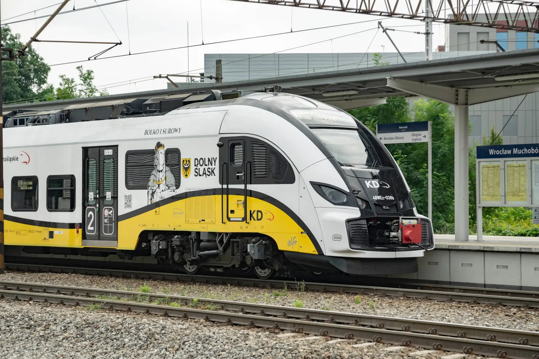 Modern white and yellow KD Koleje Dolnośląskie train at Wrocław Muchobór Wielki station